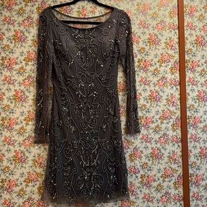 Beautifully embroidered mini cocktail dress. Back shows nuance of skin